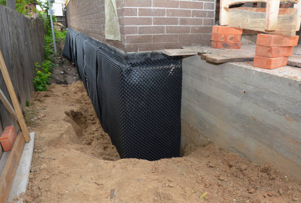 Happy homeowners after waterproofing job in Burt
